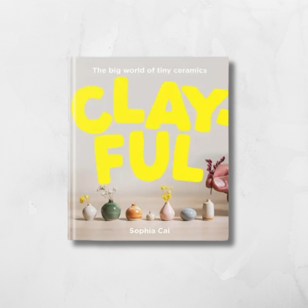 The book 'Clayful: The big world of tiny ceramics' by Sophia Cai, featuring a light beige cover with bold yellow title text and small ceramic vases along the bottom, displayed on a light gray marble-textured background.