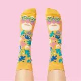 Colorful socks with cartoon face design on a pink background